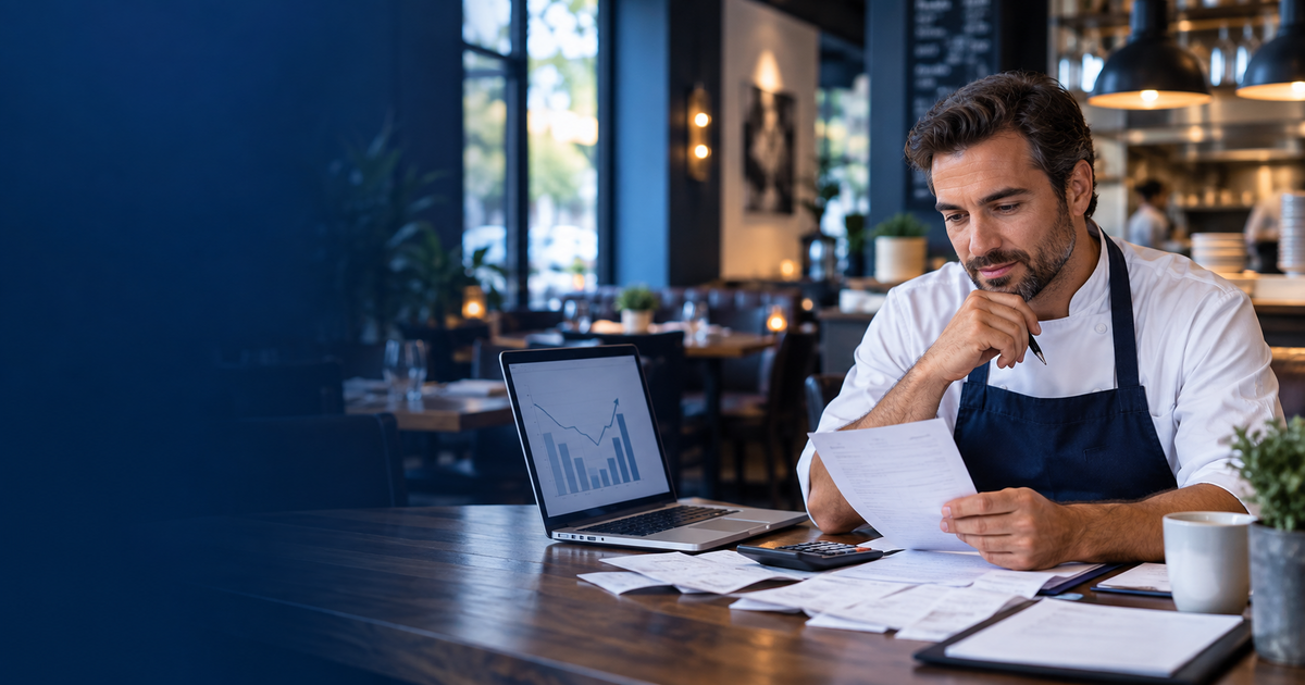 Restaurant owner reviewing expenses and cash flow inside a modern restaurant